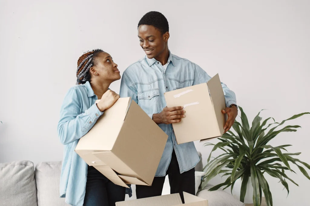 young-couple-moving-new-home-together-african-couple-with-cardboard-boxes
